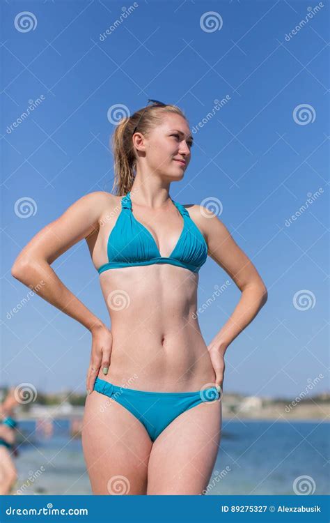 Girl In Bikini Posing With Arms Akimbo Looking Away Stock Image Image