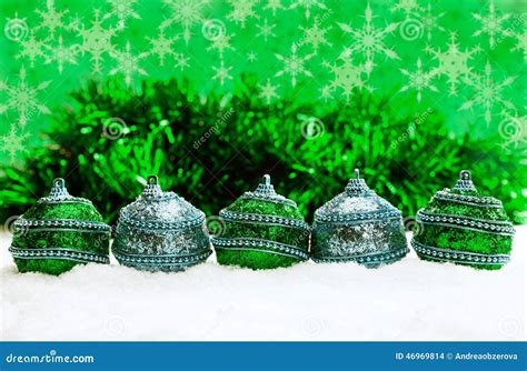 Green And Blue And Silver Christmas Balls In Snow With Tinsel And