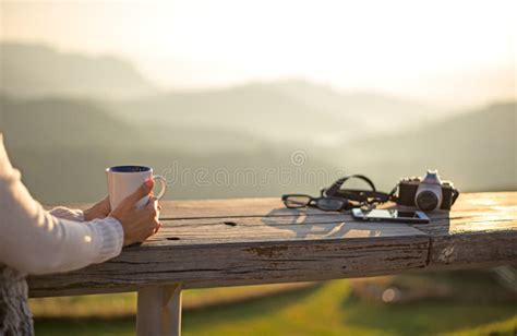 Woman Drinking Coffee In Sun Sitting Outdoor In Sunshine Light Enjoying