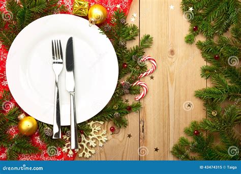 Christmas Dinner White Plate With Cutlery On Wooden Background Stock