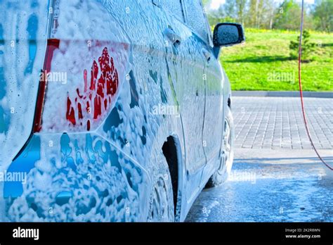 Outdoor car wash with snow foam car wash shampoo Stock Photo - Alamy