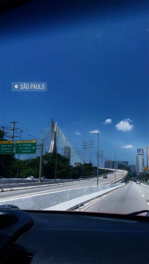 The View From Inside A Car Driving On A Highway With Tall Buildings In