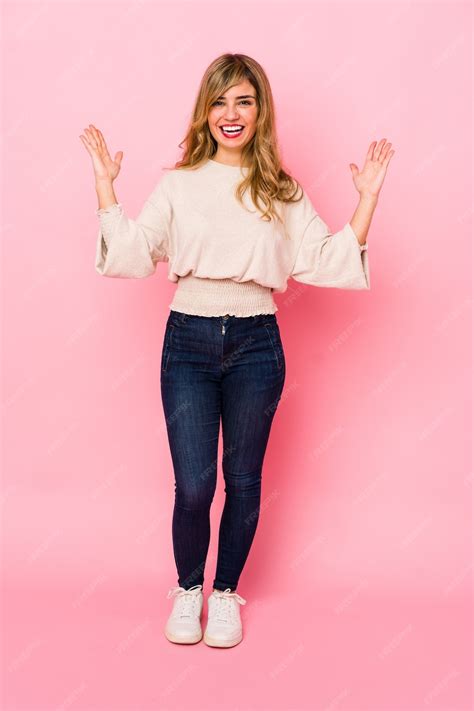 Premium Photo Young Blonde Caucasian Woman Standing Over A Pink