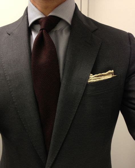 A Maroon Tie Against A Light Slate Colored Shirt And Charcoal Suit Is The Perfect Combination