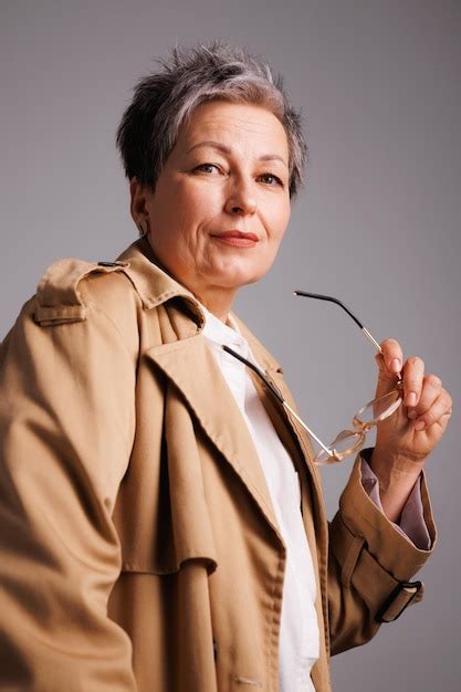 Premium Photo Portrait Of Elegant Woman Holding Eyeglasses And Posing