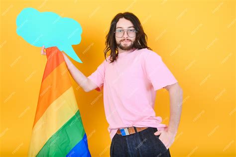 Premium Photo Handsome Young Man With Pride Movement Lgbt Rainbow Flag On Shoulder Against