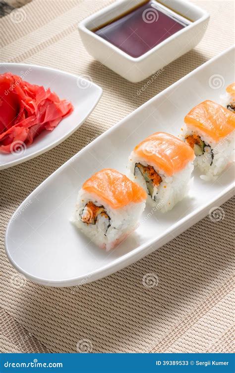 Sushi Rolls In White Plate With Chopsticks And Japanese Spices Stock