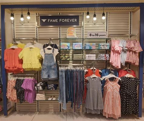 Clothes Are On Display In A Clothing Store