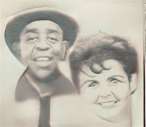 An Old Black And White Photo Of Two People Wearing Hats One Smiling At