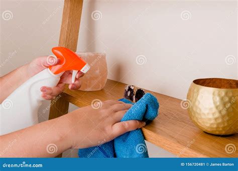 Maid Dusting Surface Housekeeper Doing Chores And Cleaning Shelf Stock