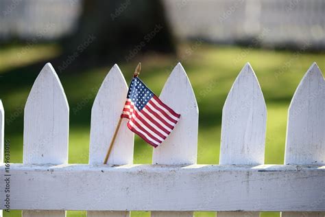 American Flag on white picket fence Stock Photo | Adobe Stock