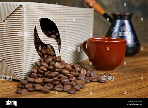 Coffee Beans Spill Out Of The Box On The Table Stock Photo Alamy