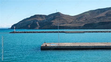 Seascape With A Lighthouse On The Kuzu Limani Harbour On The Island Of