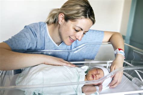 Mother With Her Newborn Baby At The Hospital A Day After A Natural