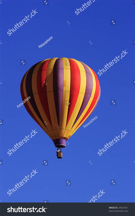 A Colorful Hot Air Balloon Floating In The Blue Sky Stock Photo