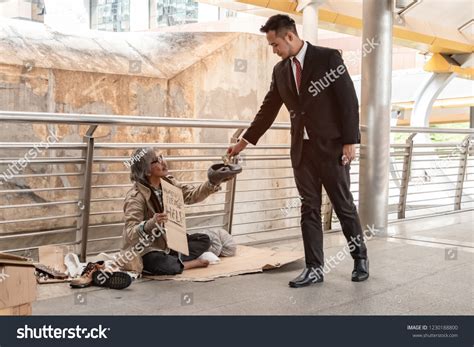 Man Giving Money To Homeless