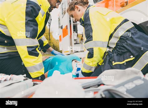 Paramedics Performing First Aid At Ambulance Stock Photo Alamy