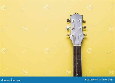 The Neck of a Classic Six-string Guitar on a Yellow Background Stock ...