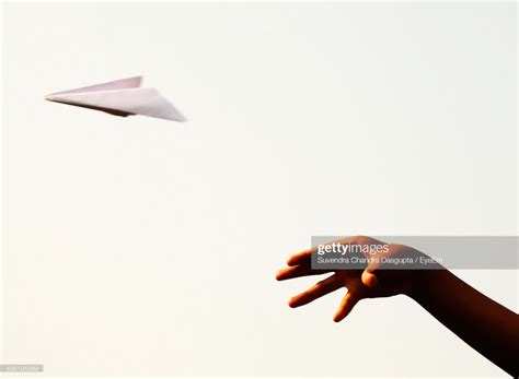 Close up of hand throwing paper airplane – Artofit