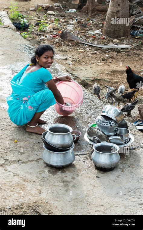 Young Indian Woman Washing Dishes Outside Their Rural Indian Village