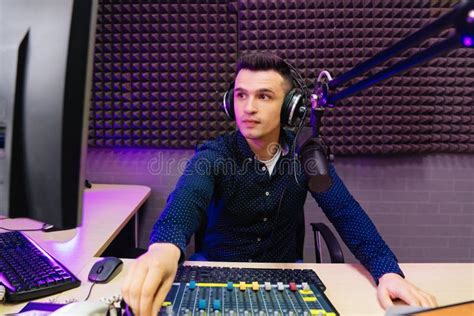 A Radio Host Conducts A Live Broadcast In A Professional Radio Studio