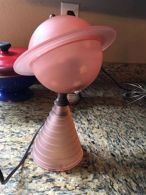 A Pink Lamp Sitting On Top Of A Counter