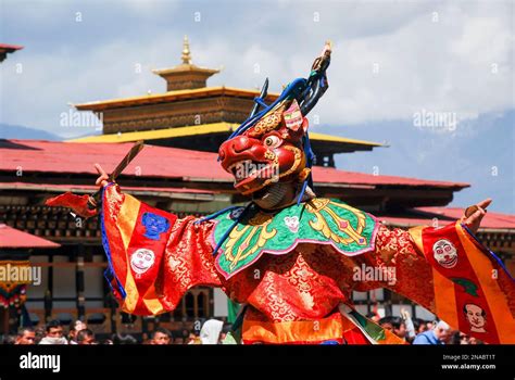 A Performer In Costume Does A Cham Dance At The Bhutanese Paro Tshechu