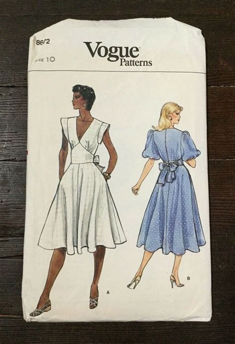 A Women S Dress And Top Sewing Pattern On A Wooden Surface With The