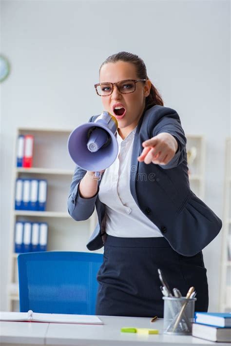 The Angry Businesswoman Yelling With Loudspeaker In Office Stock Image