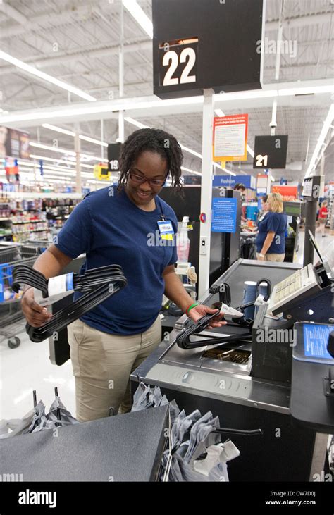 Smiling African American Female Cashier Rings Up Products For Customer