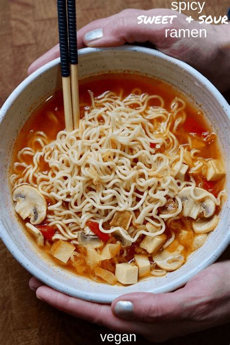 Two Hands Holding A Bowl Of Ramen With Chopsticks In It And The Words