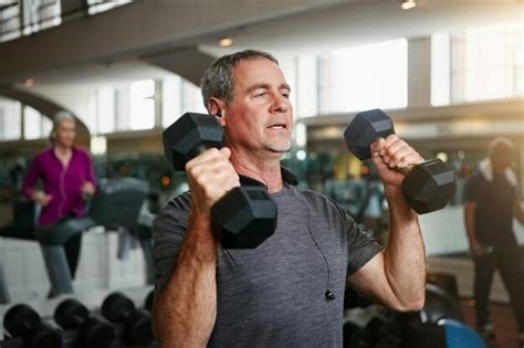 Premium Photo | Old man senior fitness and dumbbells at a gym for ...