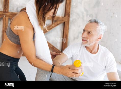 Attentive Brunette Helping To Raise Arm Correctly Stock Photo Alamy