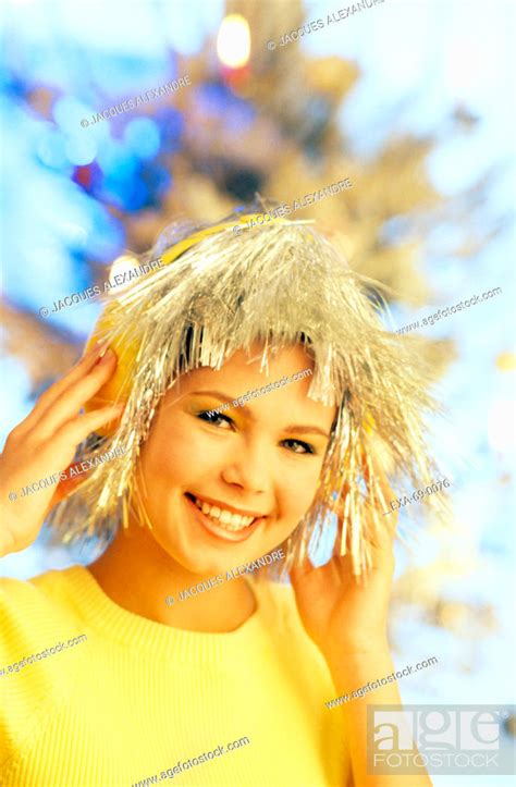 Girl Wearing Tinsel Wig And Earmuffs Stock Photo Picture And Rights