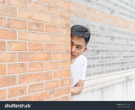 Man Hiding Behind Wall