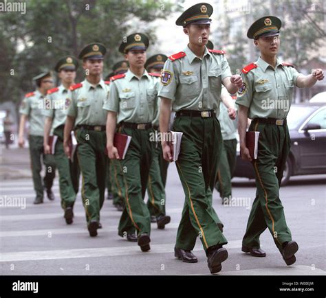 Chinese People Liberation Army (PLA) soldiers march with their books ...