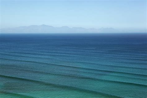 Waves Rippling On Calm Ocean Waters by Image source