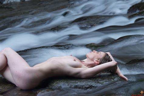 Glamour Model Sloane Vdc Lies Naked On Rocks In A Shallow Stream