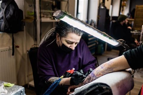 Premium Photo A Tattoo Artist Makes A Tattoo In A Salon