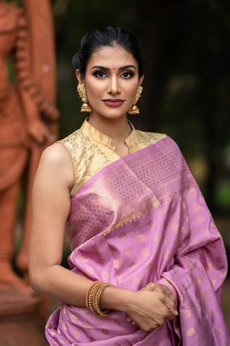 In A Elegant Pink Color Saree Gold Color Collar And Sleeveless Blouse