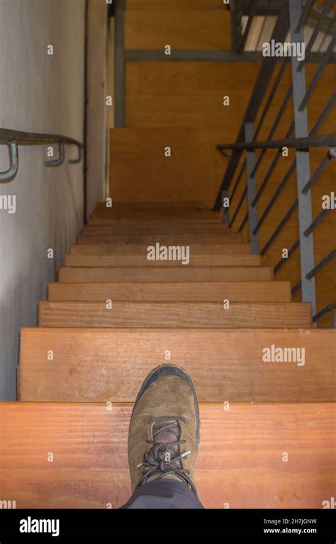 Very steep and narrow stairs. Man stand over first step Stock Photo - Alamy