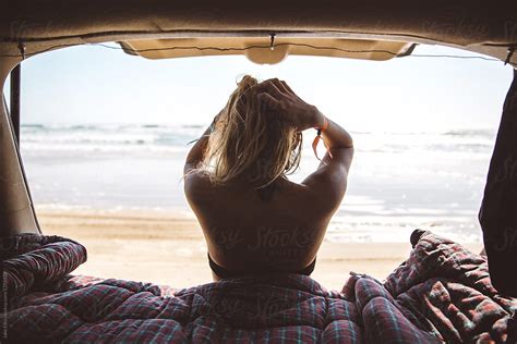 Female In Bikini Sitting In Car And Looking At The Ocean By Stocksy Contributor Jake Elko
