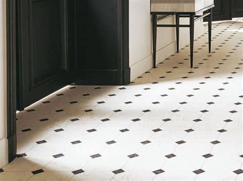 A Black And White Tiled Floor In A Kitchen