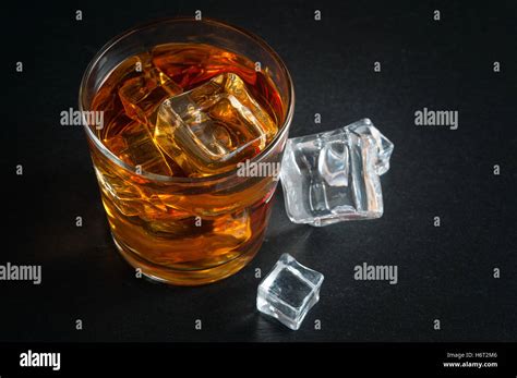 Whiskey with ice cubes Stock Photo - Alamy