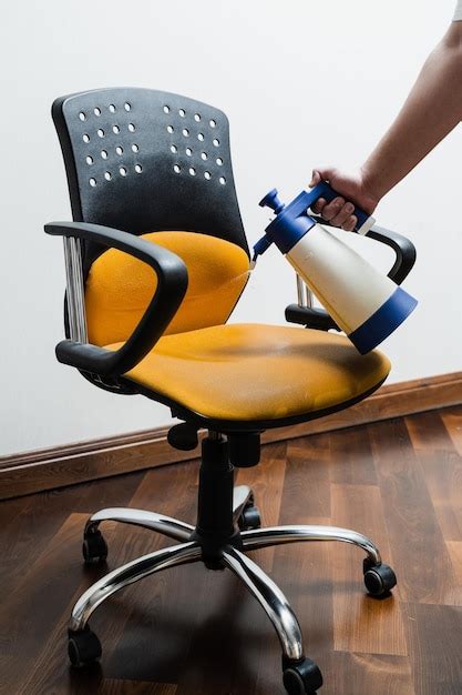 Premium Photo Spraying Detergent On Chair For Dry Cleaning Using