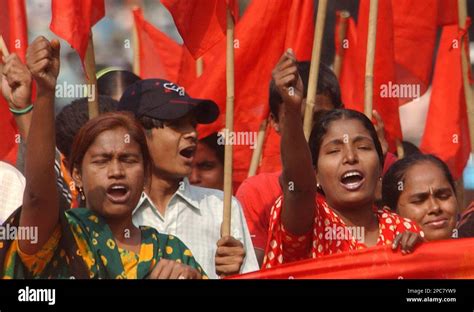 Bangladeshi Garment Workers Wave Red Flags And Shout Slogans During A