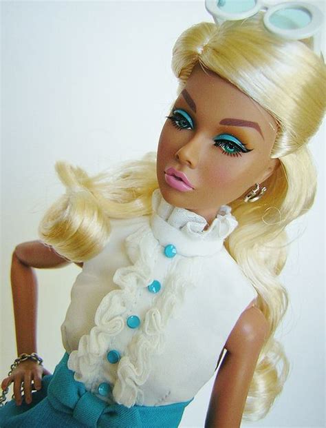 A Close Up Of A Barbie Doll With Blonde Hair And Blue Eyes Wearing A