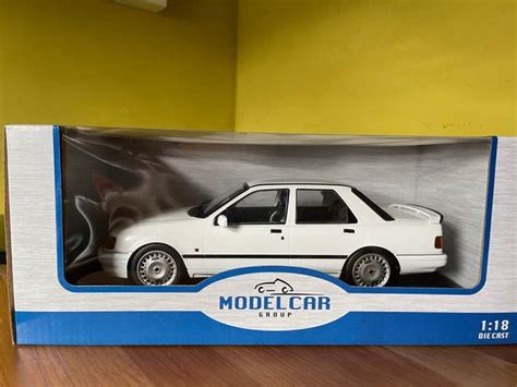 A White Model Car In A Box On A Table