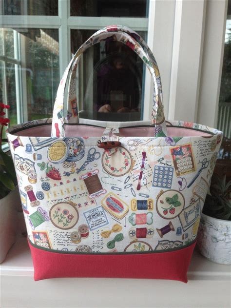 A Purse Sitting On Top Of A Window Sill Next To A Potted Plant