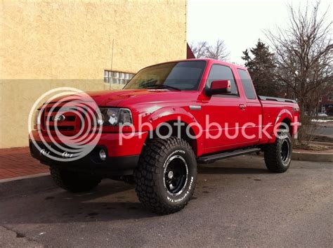 Red ford ranger with black rims